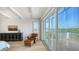 Bright bedroom with a seating area and a private balcony overlooking the water at 1300 Tangier Way, Sarasota, FL 34239