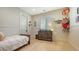 Bright bedroom with wood floors, paneled walls and a wooden dresser at 1300 Tangier Way, Sarasota, FL 34239