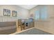 bedroom with a bed that has a play area underneath and a comfortable, gray lounge chair at 1300 Tangier Way, Sarasota, FL 34239