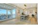 Dining area with modern lighting, bar access and an outdoor dining area via sliding doors overlooking the water at 1300 Tangier Way, Sarasota, FL 34239