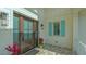 Inviting front entrance with a stylish door, tiled porch, and vibrant plants offering a warm welcome at 1300 Tangier Way, Sarasota, FL 34239