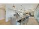Open-concept kitchen with center island, breakfast bar, stainless steel appliances, and views to living area at 1300 Tangier Way, Sarasota, FL 34239