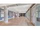 Large living room with polished concrete floors, neutral grey walls and access to a backyard patio at 1300 Tangier Way, Sarasota, FL 34239
