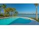 Beautiful pool surrounded by palm trees overlooking the ocean at 1300 Tangier Way, Sarasota, FL 34239