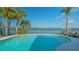 Backyard pool with palm trees overlooking the beautiful intercoastal waterway at 1300 Tangier Way, Sarasota, FL 34239