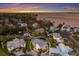 Aerial view showcases a charming home with lush landscaping, a circular driveway, and stunning water views at 1528 43Rd Avenue W Dr, Palmetto, FL 34221
