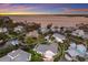 Aerial view of waterfront home near the ocean with a metal roof, landscaped yard, and private boat dock at 1528 43Rd Avenue W Dr, Palmetto, FL 34221