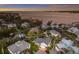 Stunning aerial view of waterfront homes at sunset with lush landscaping, boat docks, and vibrant hues at 1528 43Rd Avenue W Dr, Palmetto, FL 34221