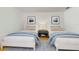 Bright bedroom furnished with two twin beds, a nightstand, and modern decor at 1528 43Rd Avenue W Dr, Palmetto, FL 34221