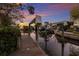 Private boat dock with lifts on a calm canal at twilight at 1528 43Rd Avenue W Dr, Palmetto, FL 34221