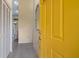 Inviting entryway with a bright yellow door, tiled floors, and closet for storage at 1528 43Rd Avenue W Dr, Palmetto, FL 34221