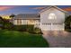 Charming two-story home with grey siding, metal roof, and a welcoming yellow front door at 1528 43Rd Avenue W Dr, Palmetto, FL 34221