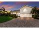 Charming two-story home with grey siding, metal roof, and a welcoming yellow front door at 1528 43Rd Avenue W Dr, Palmetto, FL 34221