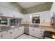 Eat-in kitchen with white cabinets, granite counters and stainless steel appliances at 1528 43Rd Avenue W Dr, Palmetto, FL 34221