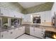 Eat-in kitchen with white cabinets, granite counters and stainless steel appliances at 1528 43Rd Avenue W Dr, Palmetto, FL 34221