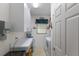 Functional laundry room with white cabinets, countertops, a utility sink, and new washer/dryer at 1528 43Rd Avenue W Dr, Palmetto, FL 34221