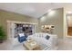 Open living room with tile flooring, neutral decor and easy access to the kitchen and outdoor spaces at 1528 43Rd Avenue W Dr, Palmetto, FL 34221