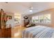 Main bedroom with wood floors, ceiling fan, bright windows and ample natural light at 1528 43Rd Avenue W Dr, Palmetto, FL 34221
