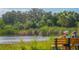 Relaxing park view with a bench overlooking tranquil waters, surrounded by lush greenery and native plants at 1528 43Rd Avenue W Dr, Palmetto, FL 34221