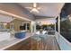 Inviting screened porch with dining table, fan, and water views through sliding glass doors at 1528 43Rd Avenue W Dr, Palmetto, FL 34221