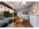Relaxing porch features a TV, ceiling fan, wicker chairs, and water views at 1528 43Rd Avenue W Dr, Palmetto, FL 34221