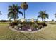 The entrance to Snead Island is marked by a welcoming sign surrounded by colorful landscaping and palm trees at 1528 43Rd Avenue W Dr, Palmetto, FL 34221