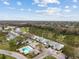 Aerial view of the community pool, golf course, and various townhome buildings at 16211 Rambling Vine W Dr, Tampa, FL 33624