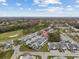 Aerial view of a community featuring well-maintained homes and a nearby golf course at 16211 Rambling Vine W Dr, Tampa, FL 33624
