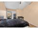 Bedroom featuring a ceiling fan and sliding glass doors to the patio at 16211 Rambling Vine W Dr, Tampa, FL 33624