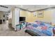 Bedroom showcasing wood floors, ceiling fan, striped walls, and a blanket-covered bed at 16211 Rambling Vine W Dr, Tampa, FL 33624