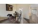 Charming dining area with views into the kitchen and entryway, featuring hardwood floors at 16211 Rambling Vine W Dr, Tampa, FL 33624