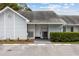 Charming light blue townhome with a rocking chair on the front porch and assigned parking spaces at 16211 Rambling Vine W Dr, Tampa, FL 33624