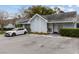 Quaint light blue townhome with a car parked in the driveway and well-maintained landscaping at 16211 Rambling Vine W Dr, Tampa, FL 33624