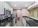 Bright kitchen with stainless steel appliances, granite countertops, and a kitchen bar at 16211 Rambling Vine W Dr, Tampa, FL 33624