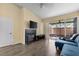 Cozy living room featuring a fireplace, hardwood floors, and patio access through a sliding door at 16211 Rambling Vine W Dr, Tampa, FL 33624
