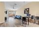 Bright living room featuring hardwood floors, a vaulted ceiling, and sliding door access to the patio at 16211 Rambling Vine W Dr, Tampa, FL 33624