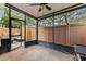 Screened patio featuring a black metal enclosure and a view of the wooded backyard at 16211 Rambling Vine W Dr, Tampa, FL 33624