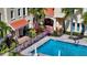 Overhead shot of community pool, palm trees, lounge chairs, and well-maintained landscaping at 1685 Laurel St # 4, Sarasota, FL 34236