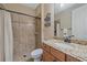 Bathroom with a granite-topped vanity and tile shower featuring bronze fixtures at 17448 Hickok Belt Loop, Bradenton, FL 34211