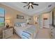 Spacious bedroom with light walls, tray ceiling, and view of the en suite bathroom at 17448 Hickok Belt Loop, Bradenton, FL 34211