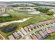 Expansive aerial view of a community featuring a golf course, scenic ponds, and neatly arranged residential houses at 17704 Gawthrop Dr # 307, Bradenton, FL 34211