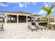 Outdoor bar and lounge area with a covered bar and grill, an umbrella table and two lounge chairs at 17704 Gawthrop Dr # 307, Bradenton, FL 34211