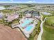 Aerial view of a resort-style pool with a waterfall feature, sun loungers, and surrounding amenities at 17704 Gawthrop Dr # 307, Bradenton, FL 34211