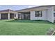 Spacious backyard featuring a well-manicured lawn and a covered patio at 18803 Dayspring Pl, Venice, FL 34293