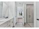 Modern bathroom featuring double vanity, tile flooring, and a glass-enclosed walk-in shower at 18803 Dayspring Pl, Venice, FL 34293
