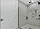 Contemporary bathroom with frameless glass shower, a rainfall showerhead, and tiled walls at 18803 Dayspring Pl, Venice, FL 34293