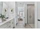 Modern bathroom featuring dual sinks, a vanity with gold hardware, and a walk-in shower at 18803 Dayspring Pl, Venice, FL 34293
