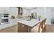 Modern kitchen with an island, stainless steel appliances, beautiful backsplash, and stylish countertops at 18803 Dayspring Pl, Venice, FL 34293