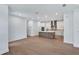 Open-concept living room with hardwood floors and views of the modern kitchen at 18803 Dayspring Pl, Venice, FL 34293