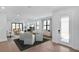Bright living room featuring modern furniture, wood flooring and large windows that let in natural light at 18803 Dayspring Pl, Venice, FL 34293